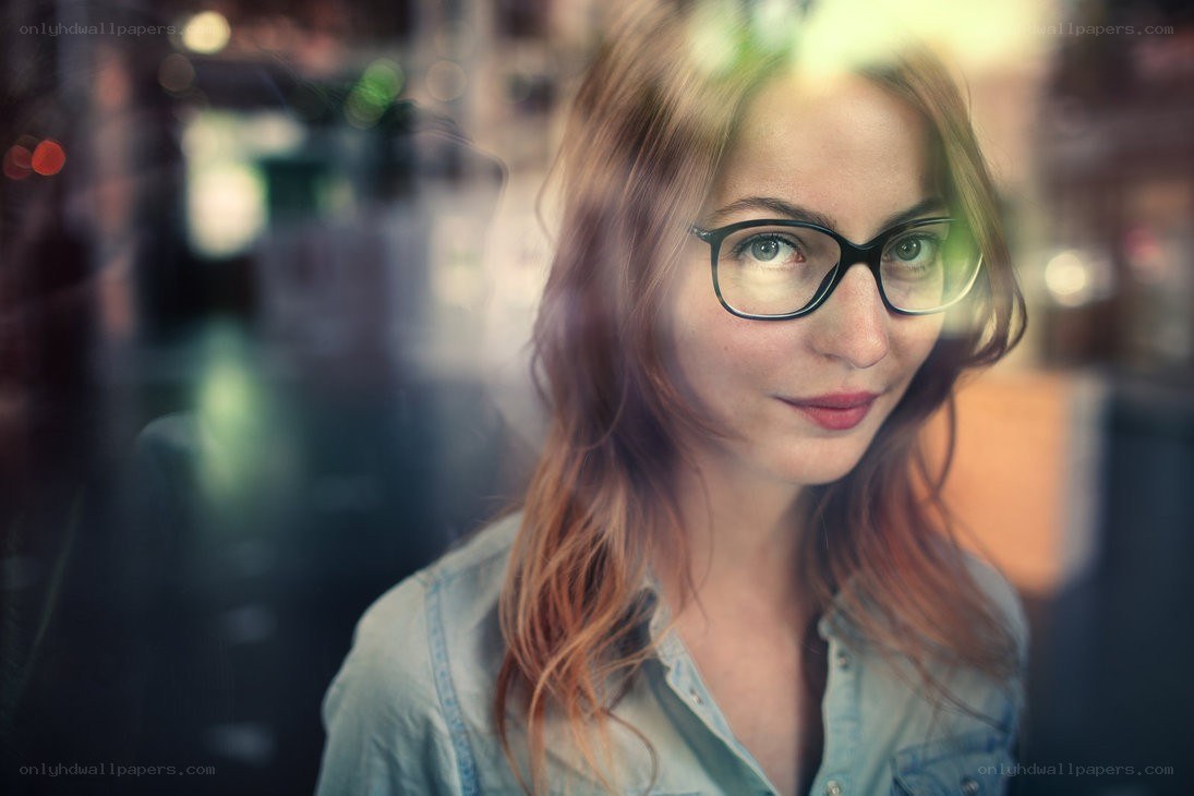 woman with glasses looking through window