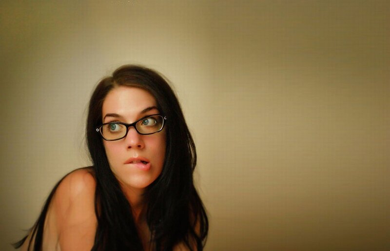 woman with glasses looking up