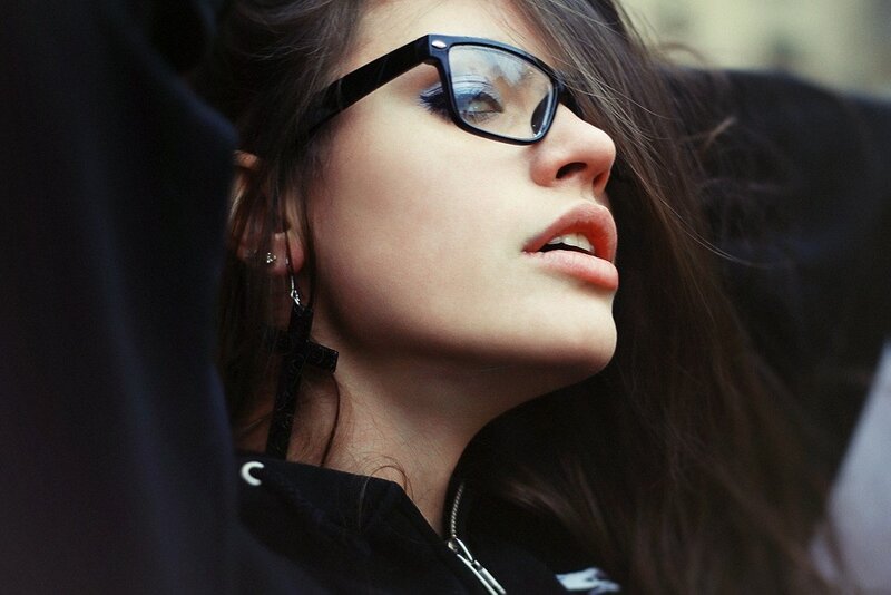 woman with glasses looking up