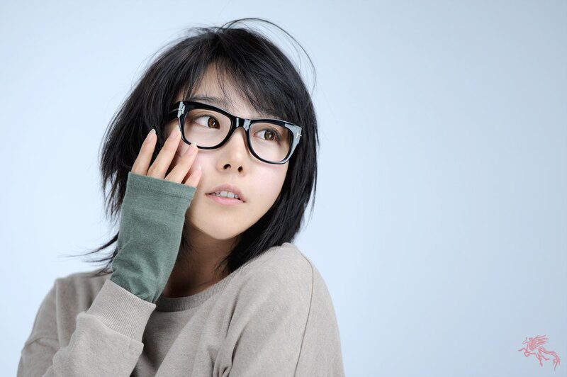 woman with glasses looking up