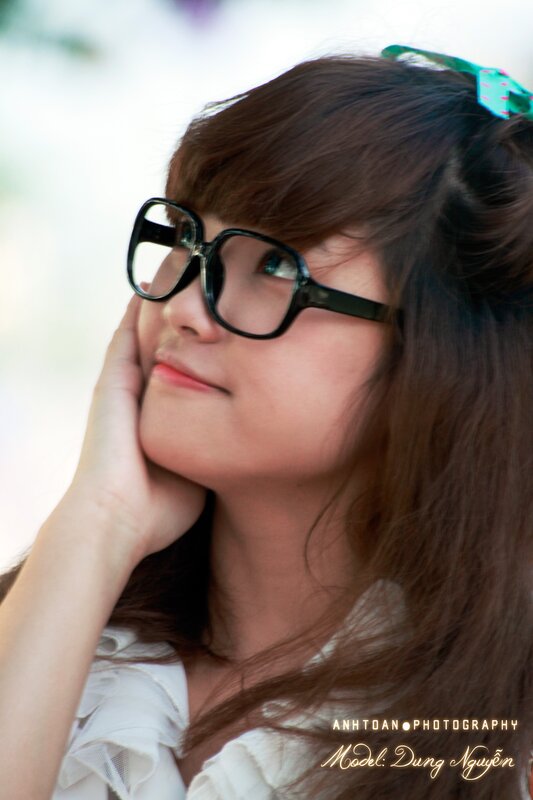 woman with glasses looking up