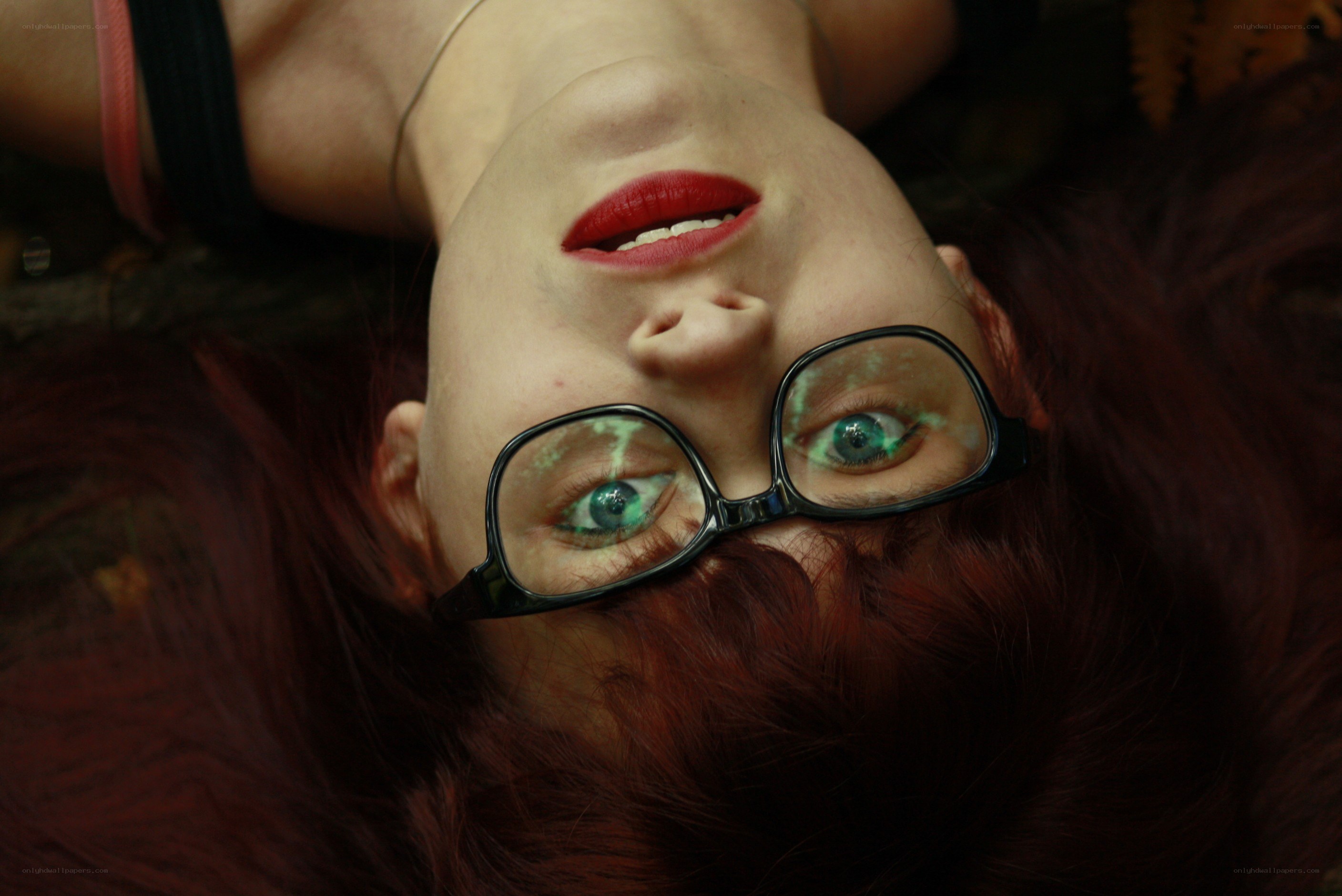 woman with glasses lying down