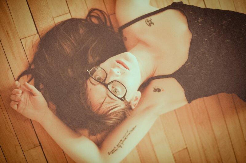 woman with glasses lying on floor