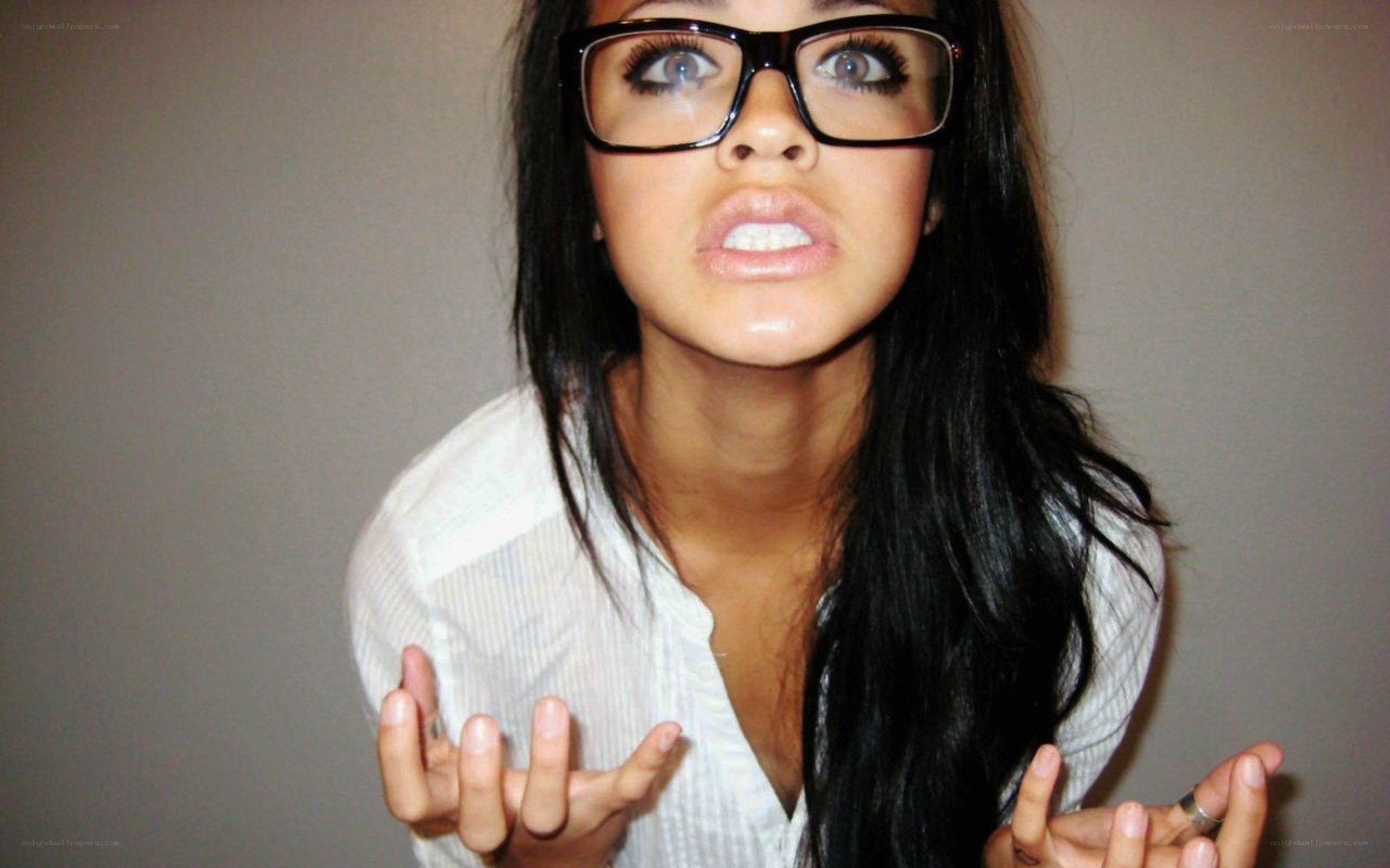 woman with glasses making a face