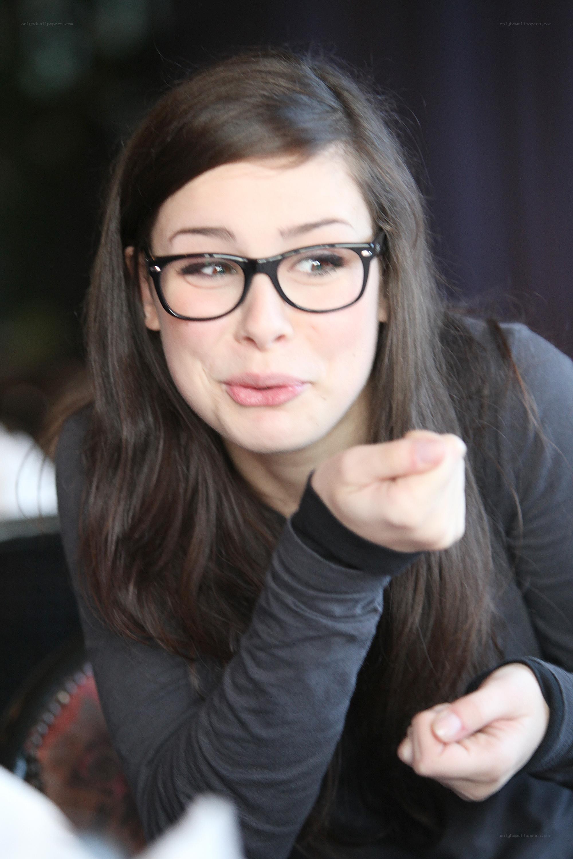 woman with glasses making a face