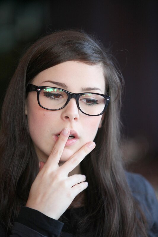 woman with glasses making a gesture