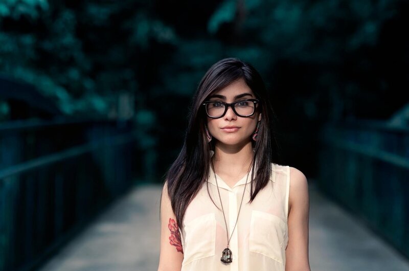 woman with glasses on a bridge