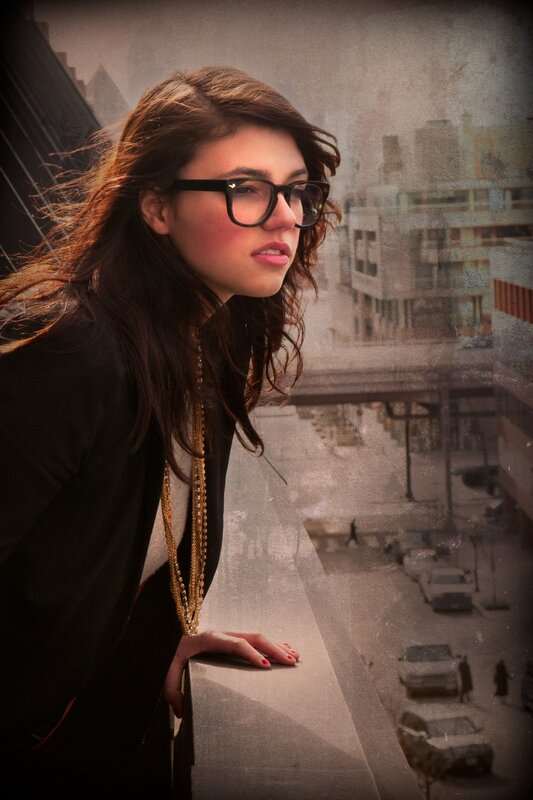 woman with glasses on balcony