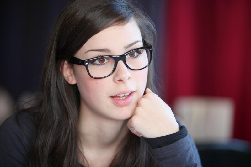 woman with glasses resting chin