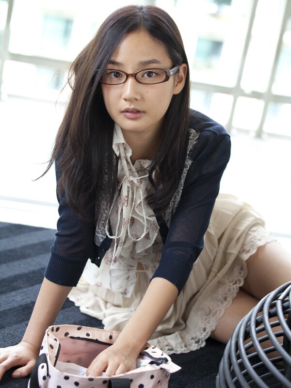 woman with glasses sitting on floor