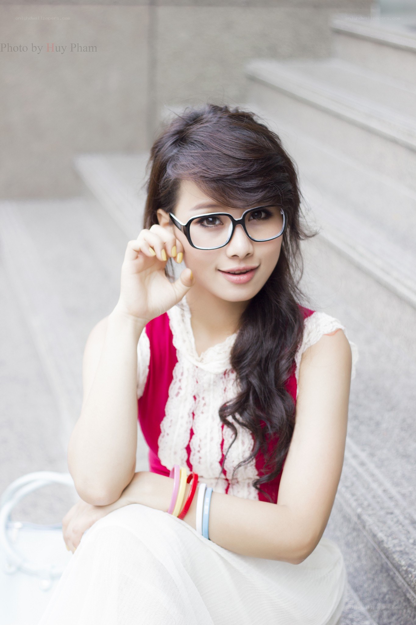 woman with glasses sitting on steps
