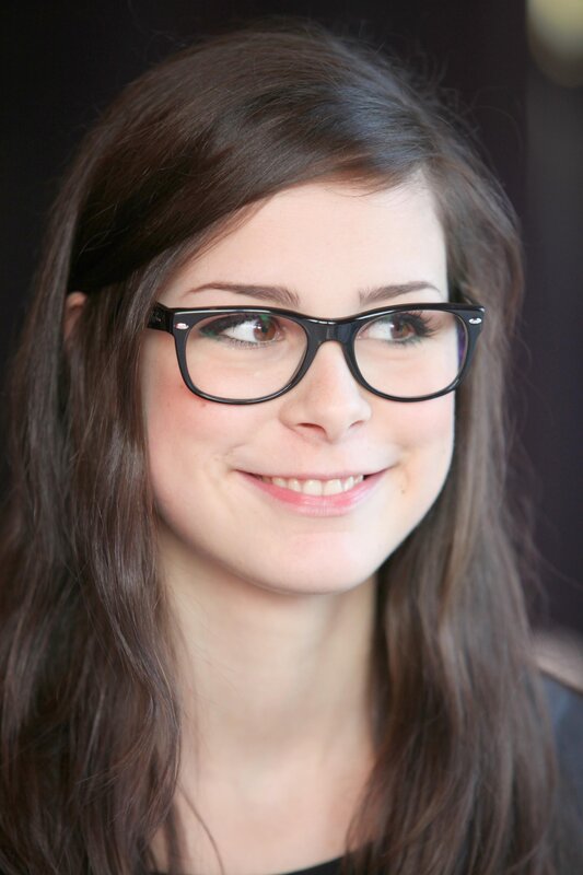 woman with glasses smiling