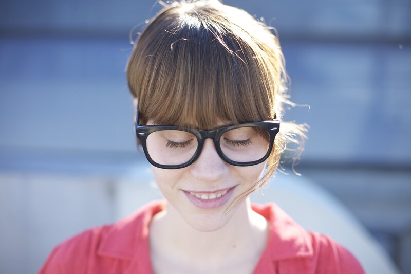 woman with glasses smiling