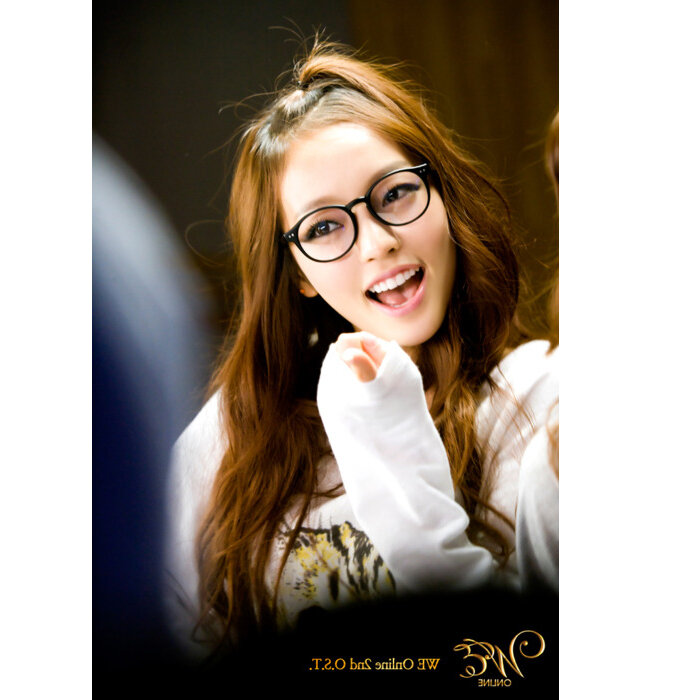 woman with glasses smiling