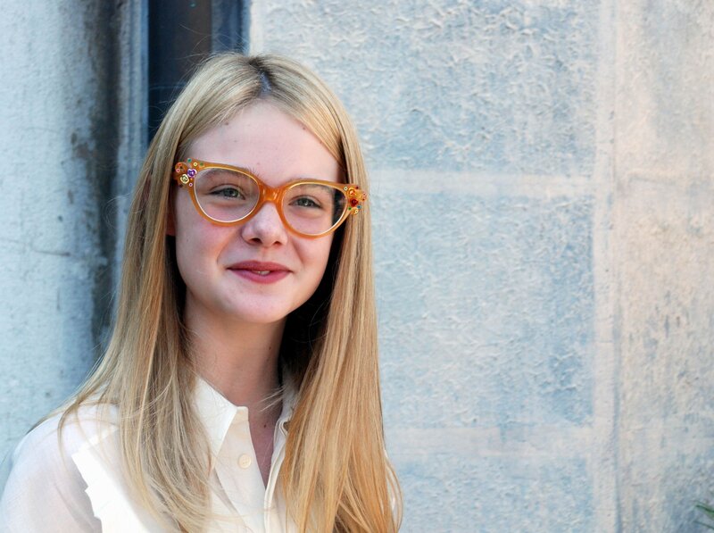 woman with glasses smiling