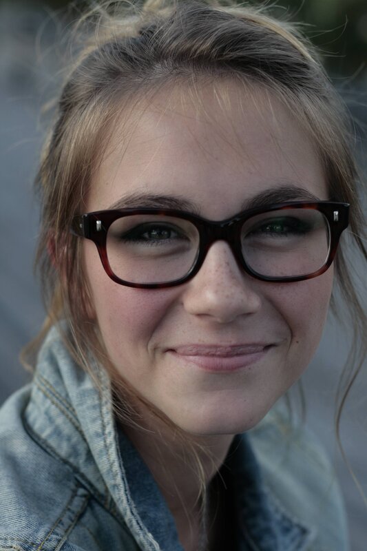 woman with glasses smiling