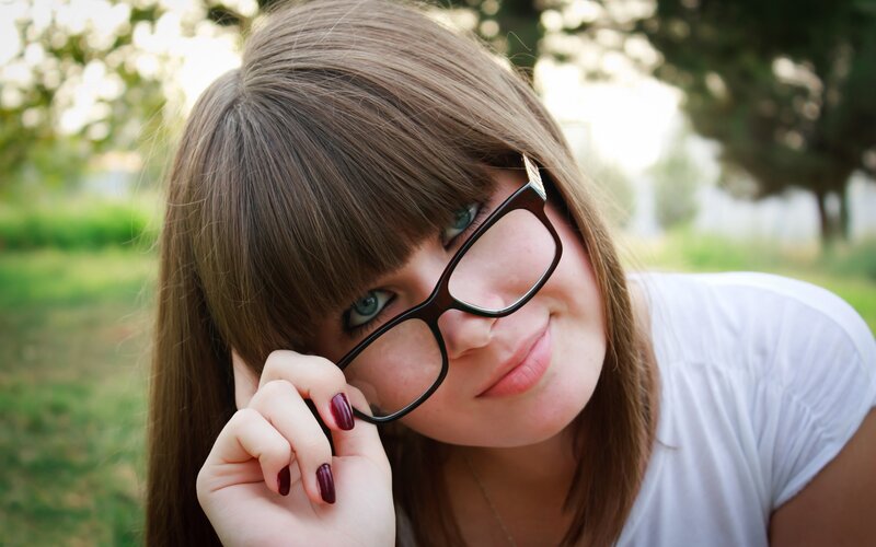 woman with glasses smiling