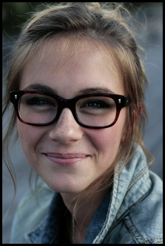 woman with glasses smiling