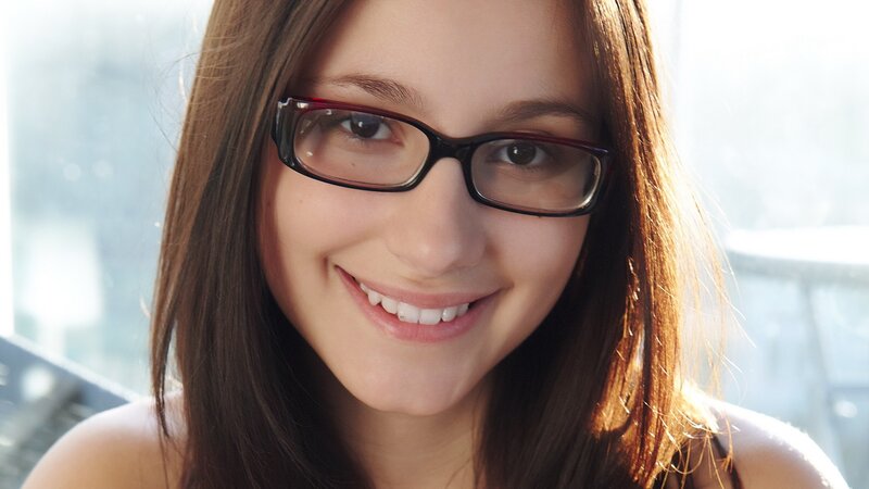 woman with glasses smiling