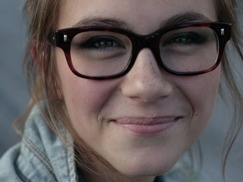 woman with glasses smiling