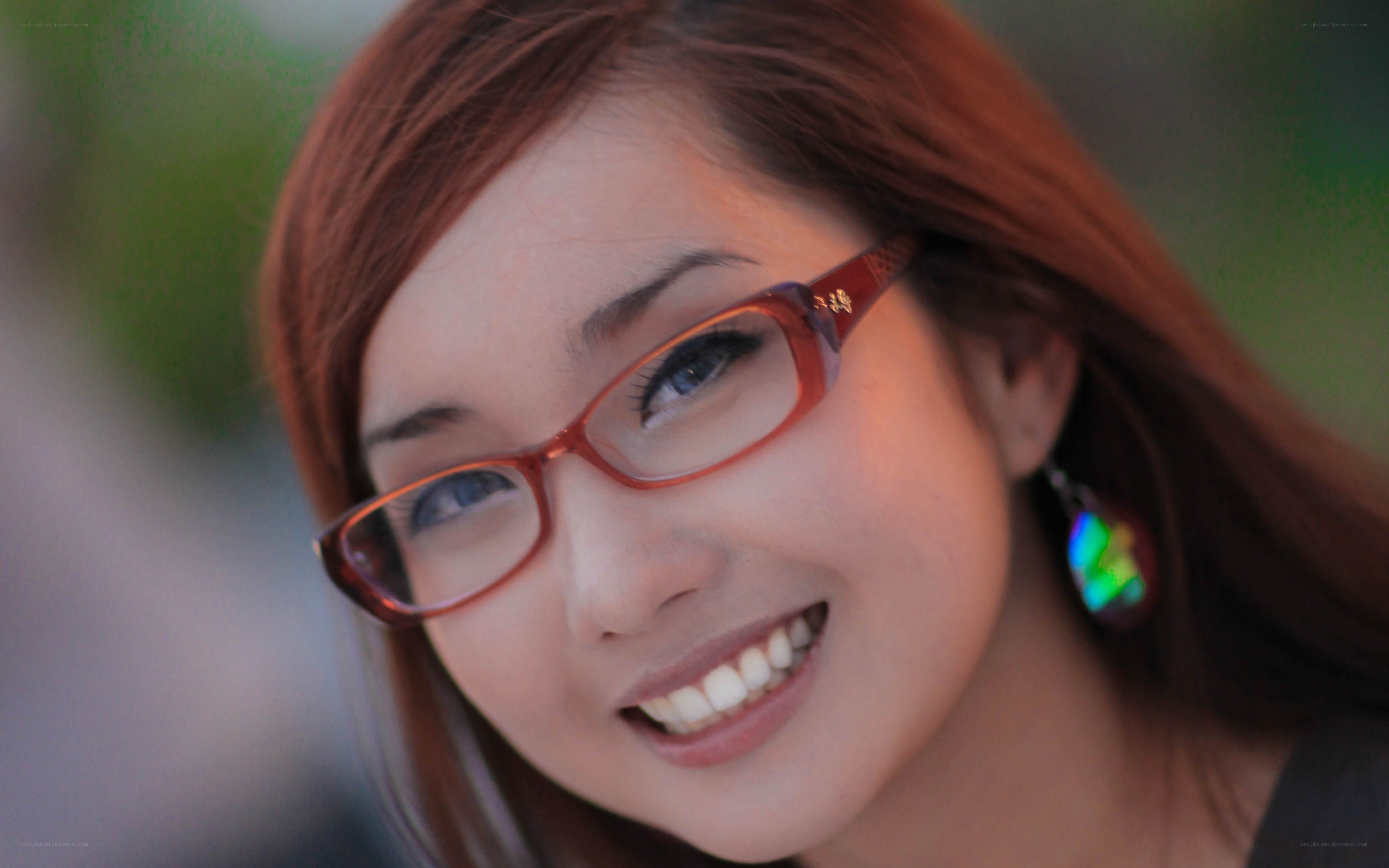 woman with glasses smiling