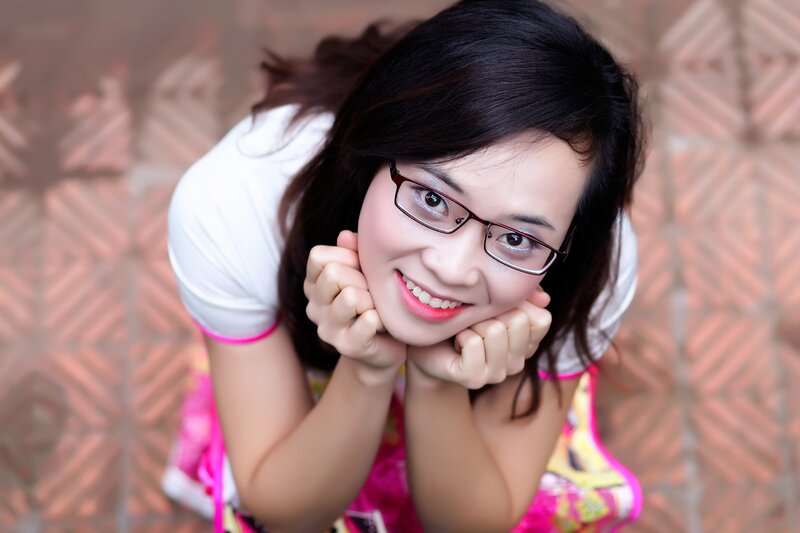 woman with glasses smiling