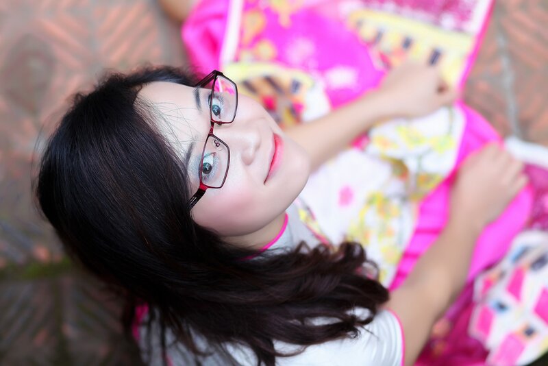 woman with glasses smiling