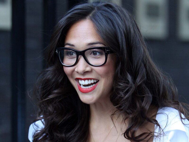 woman with glasses smiling