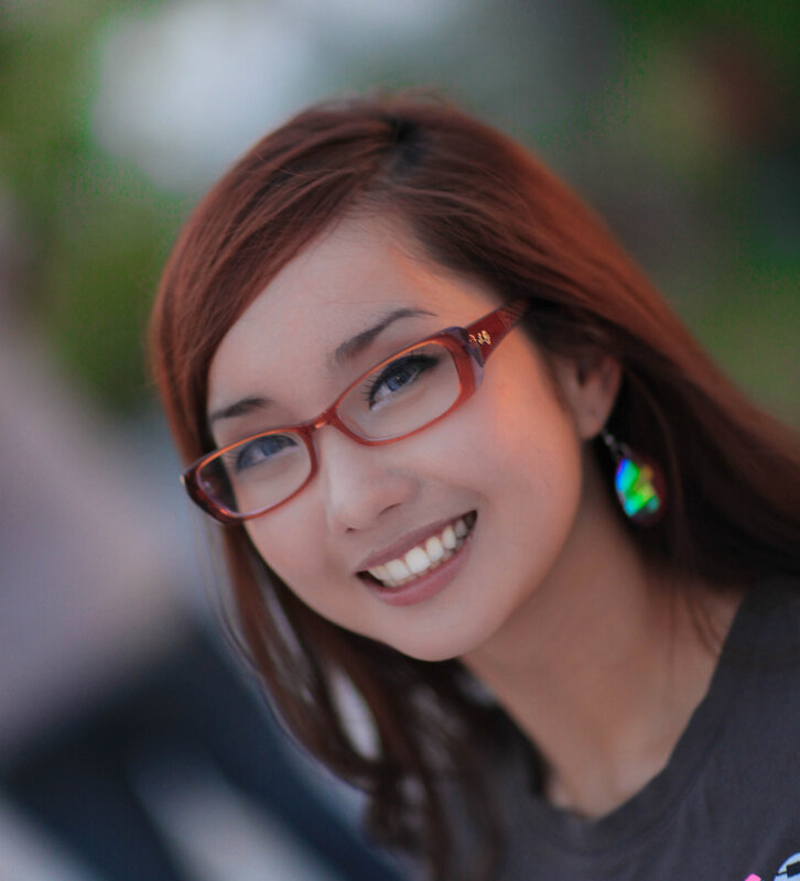 woman with glasses smiling