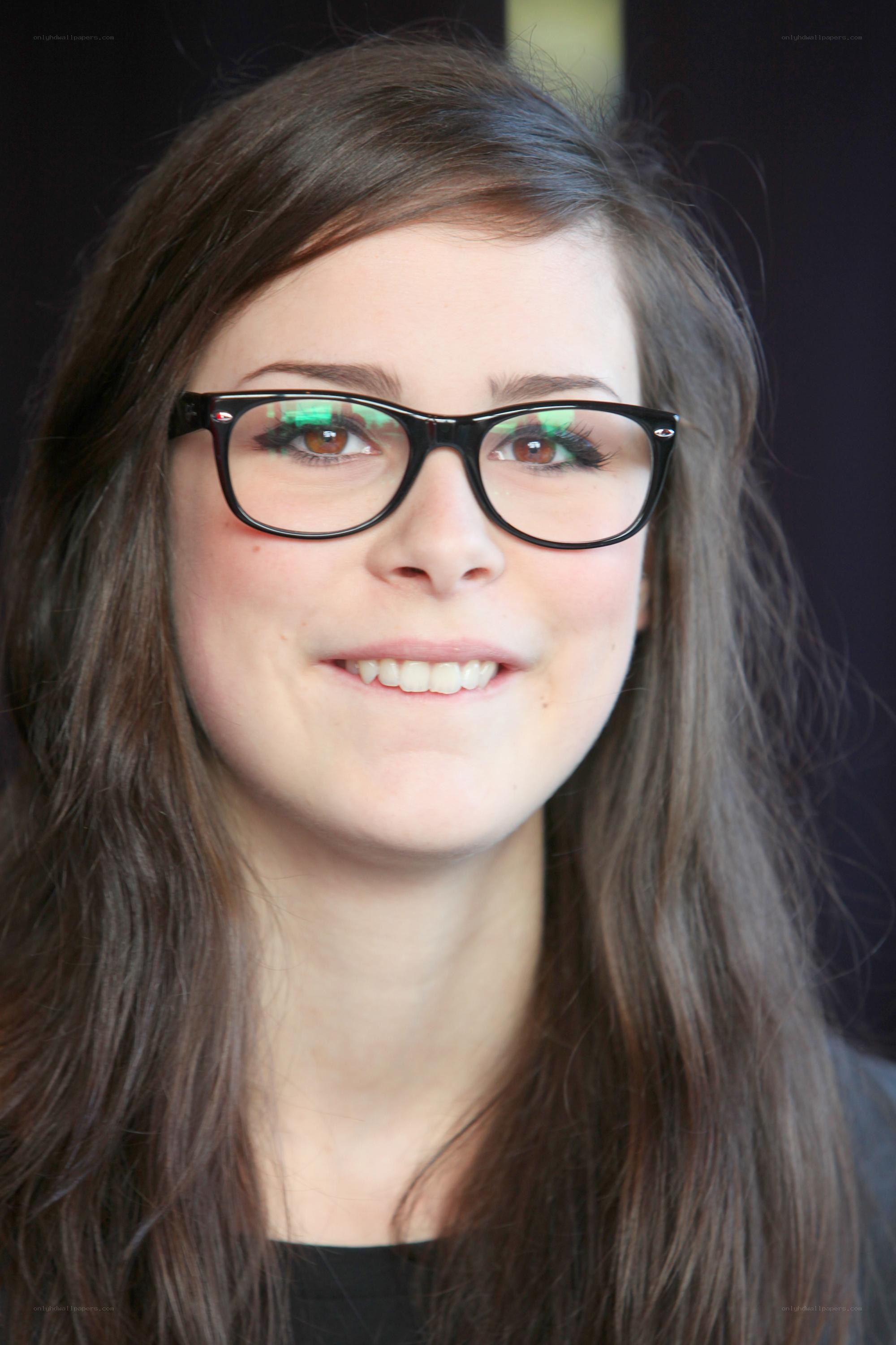 woman with glasses smiling
