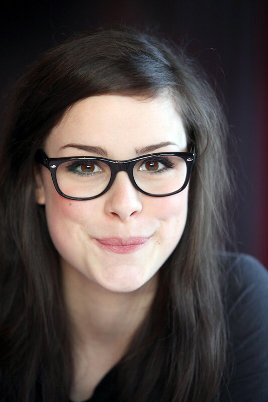 woman with glasses smiling