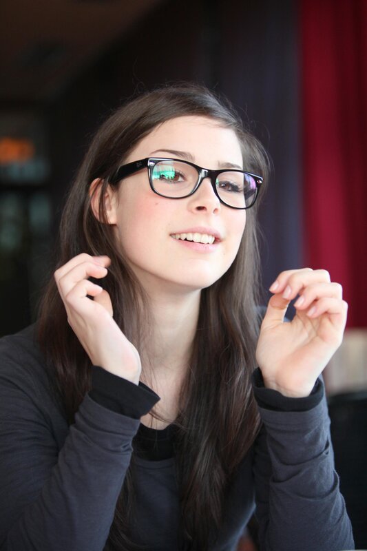 woman with glasses smiling