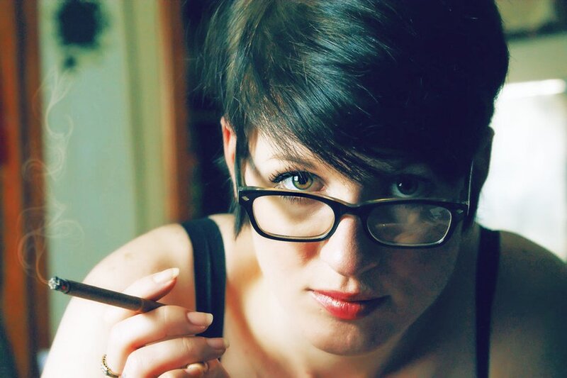 woman with glasses smoking