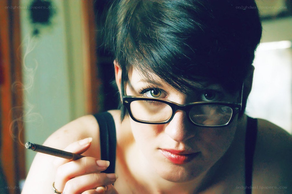 woman with glasses smoking
