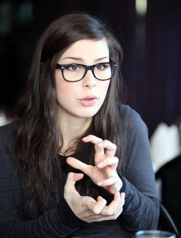 woman with glasses speaking