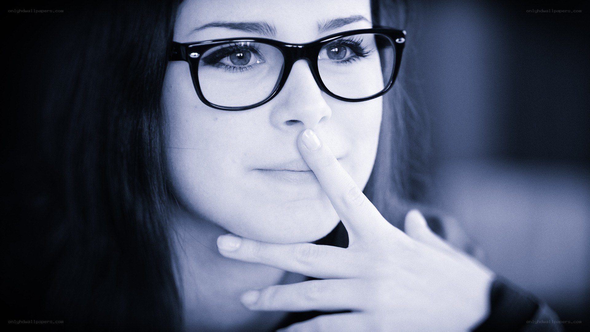 woman with glasses thinking