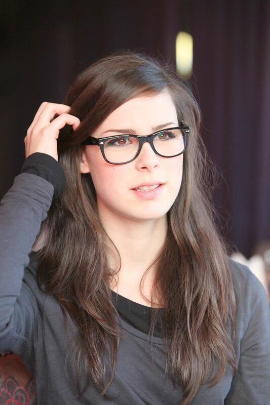 woman with glasses touching hair