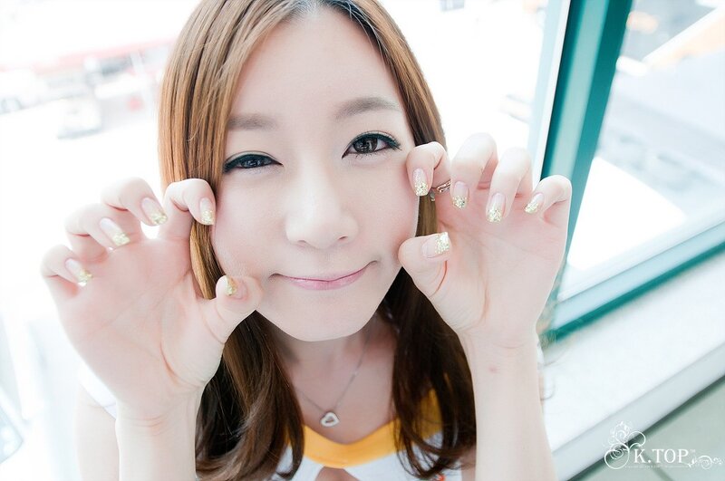 woman with glitter nails smiling