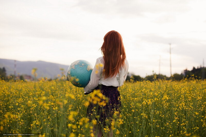 Woman with globe in a field