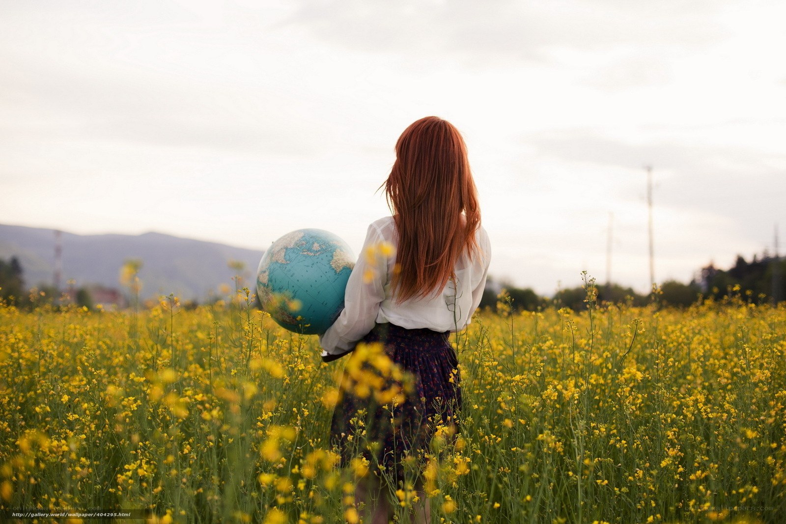 Woman with globe in a field
