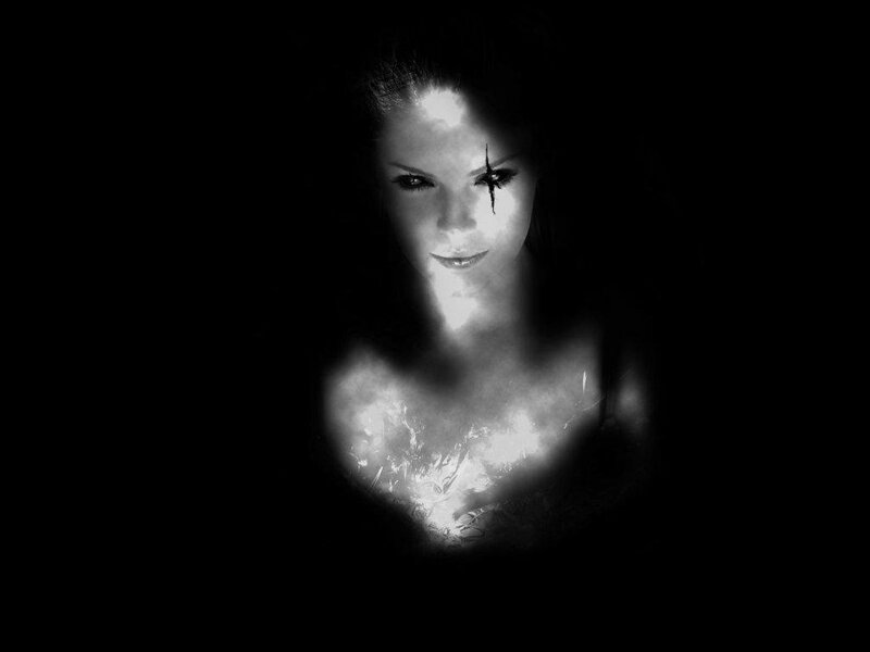 woman with glowing chest and dark makeup