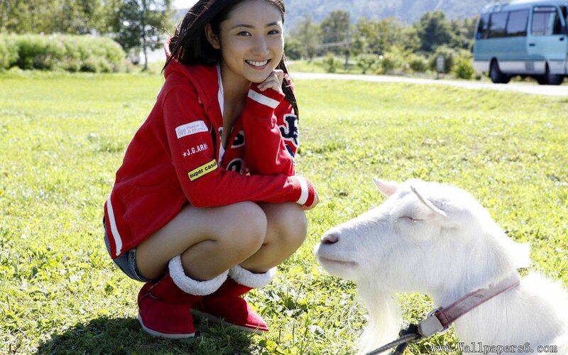Woman with goat in field