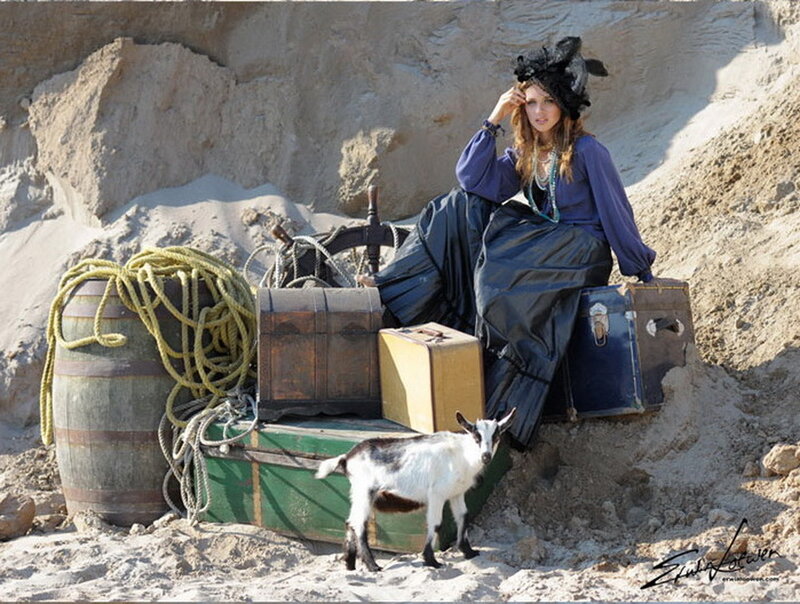 woman with goat on beach