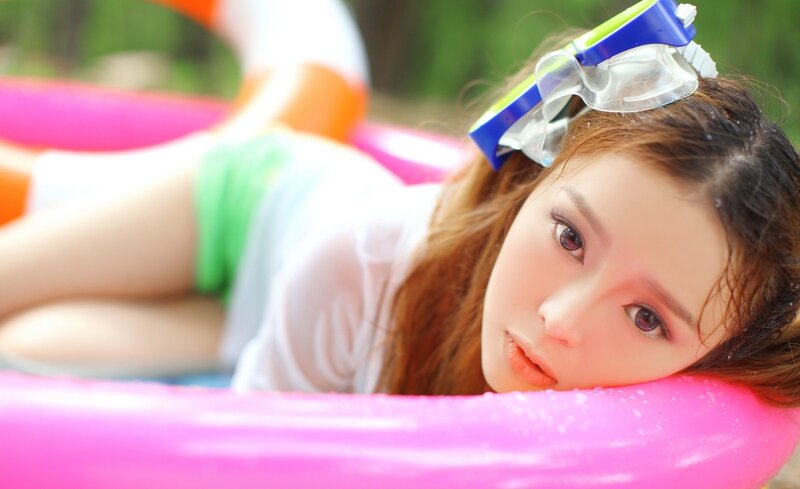 woman with goggles on pool float