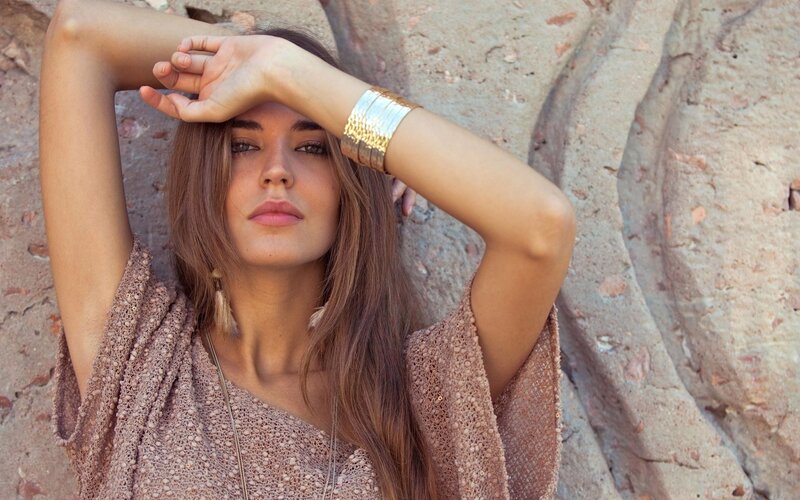 woman with gold bracelet
