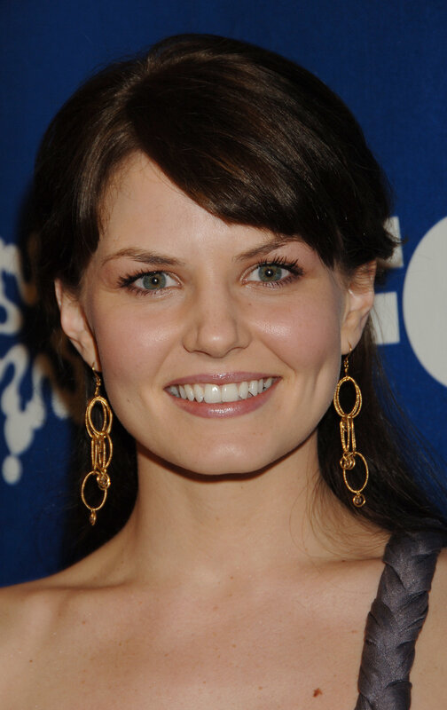 woman with gold earrings smiling