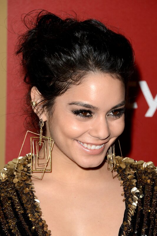 woman with gold earrings smiling