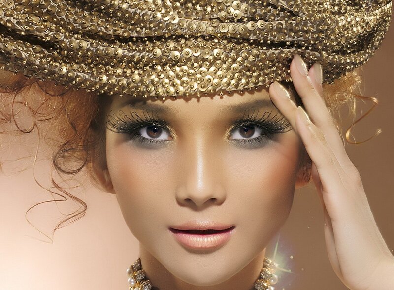 woman with gold hat and makeup