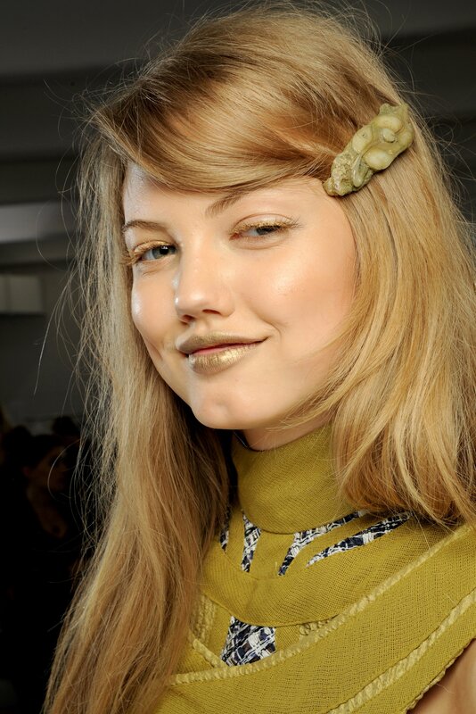 woman with gold makeup and hair clip