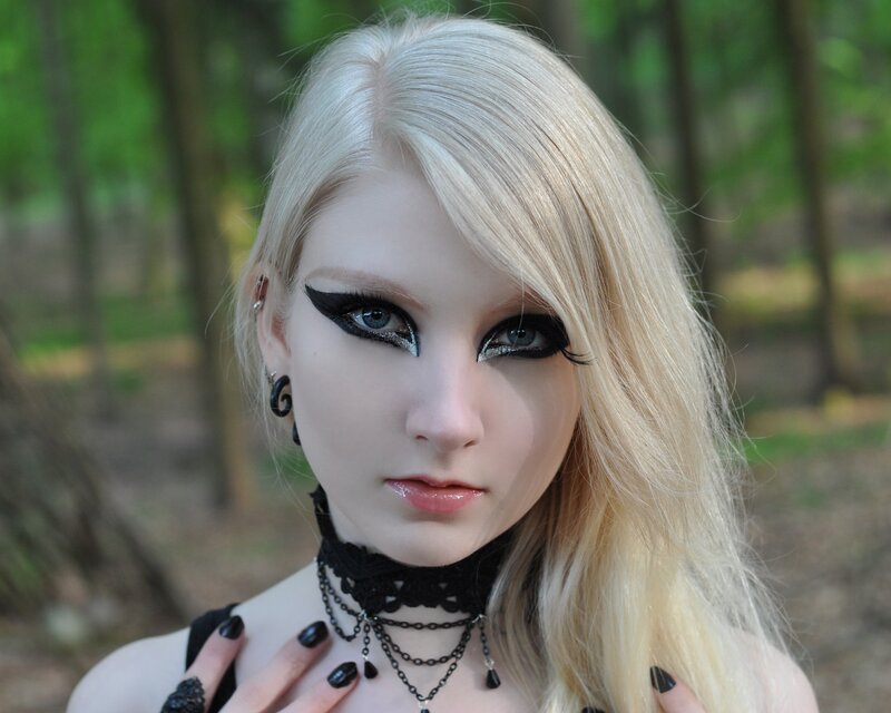 woman with goth makeup in forest